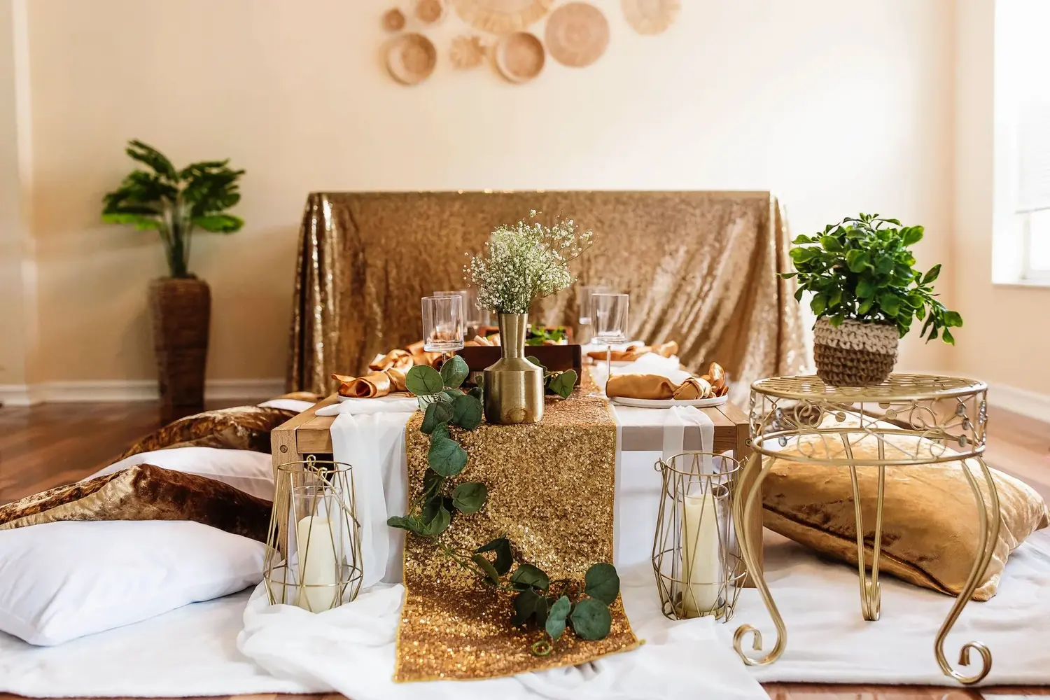 Glam gold grazing table setup with floor cushions for an adult sleepover party