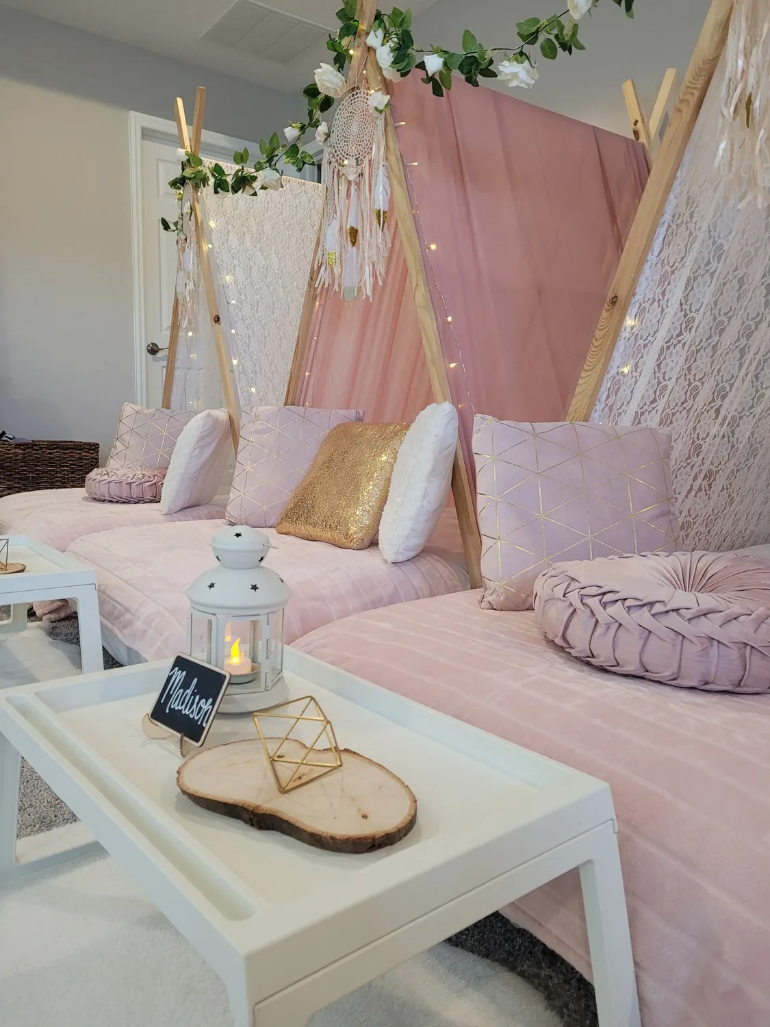 Pink teepee sleepover setup with dreamcatchers, fairy lights, and plush bedding in Tampa